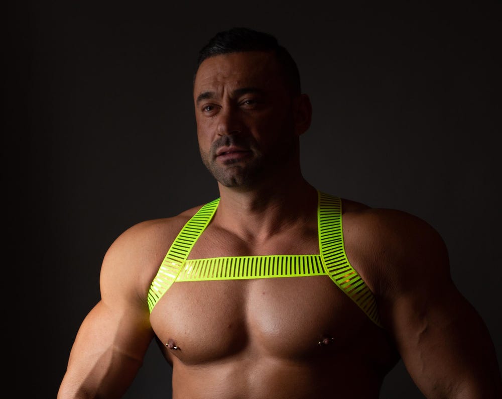 Neon green fluorescent male pride party elastic harness.
