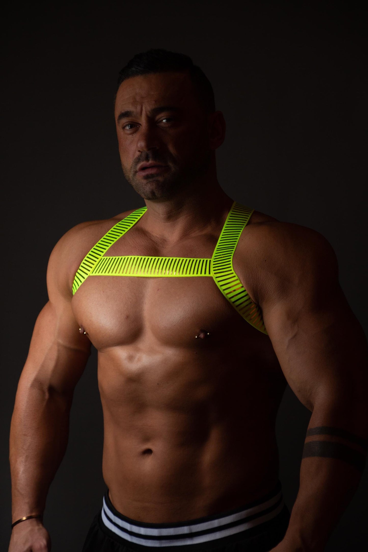 Neon green fluorescent male pride party elastic harness.