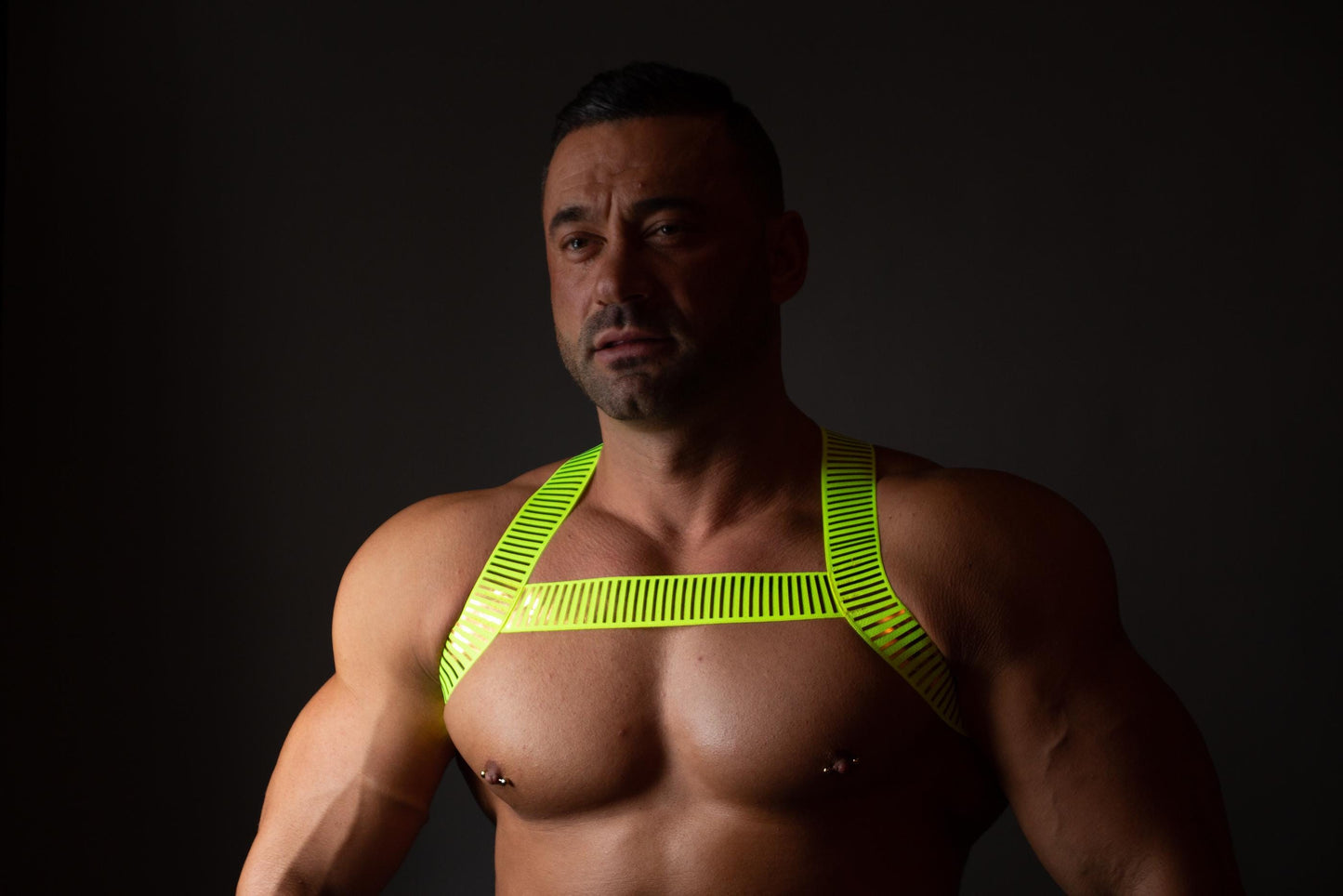 Neon green fluorescent male pride party elastic harness.